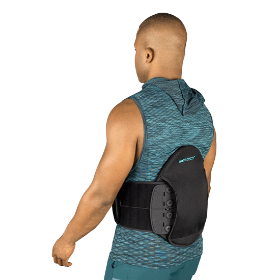 Coretech 631 lumbar brace LSO with male model wearing it, view from the back left